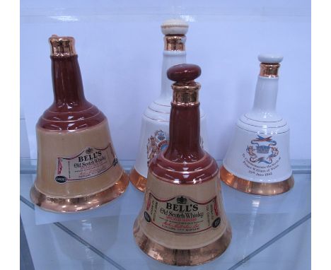 Three Bells' Scotch Whisky decanters various sizes with contents and one empty
