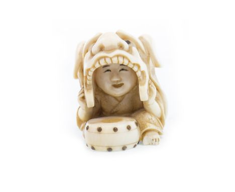 LATE 19TH CENTURY JAPANESE IVORY NETSUKE, modelled as a boy with dragon mask and drum, with red seal signature, 3cm high