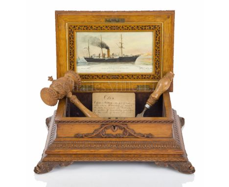 THE LAUNCHING CASKET FOR H.M.S. ODIN, 1901 ornately carved in oak with dolphin corner supports, the hinged lid with inset 4¼ 