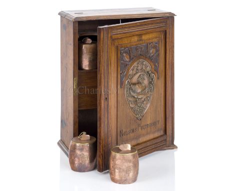 A SMOKER’S CABINET MADE FROM FOUDROYANT OAK BY GOODALL, LAMB &amp; HEIGHWAY, CIRCA 1898 the door with copper plaque of the wr