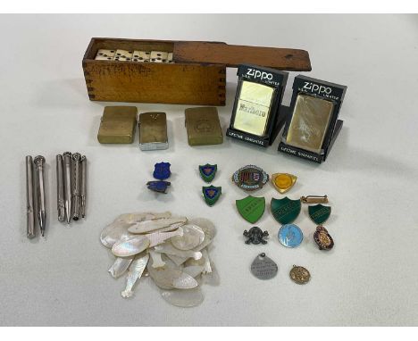 A group of collectors' items, including mother of pearl gaming counters, badges, Zippo lighters, dominoes, pencils, etc.