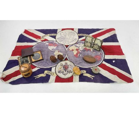 A group of collectors' items, including daguerreotype photographs, brass snuff box, Mauchline ware money bank, a flag, carved