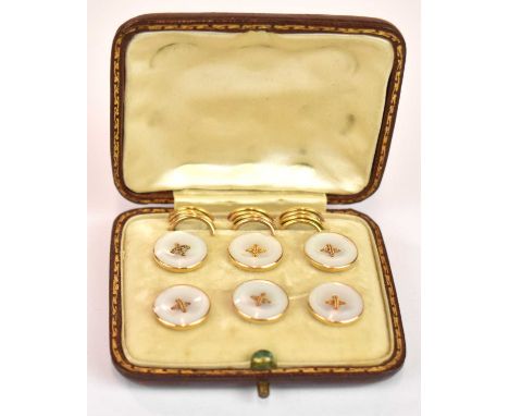 A cased set of six Edwardian 15ct yellow gold button studs with mother of pearl faces, complete with the six backing loops (l