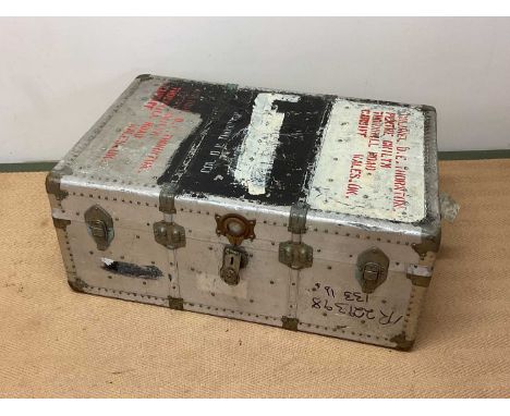 Aluminium travelling trunk with rivet detailing, height 37cm, width 93cm, depth 61cm.