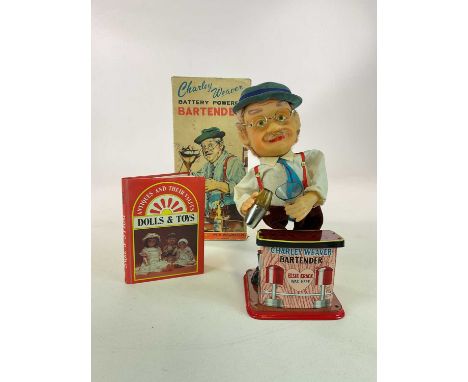 A battery operated Charley Weaver Bartender automaton in original box by Rostock Toys, and a Dolls and Toys book with Charley