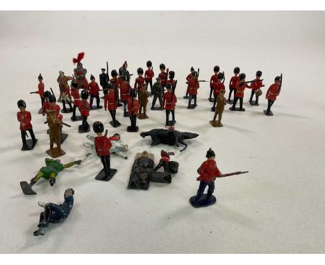 A group of painted vintage lead soldiers, also a tin plate field gun, and a bisque head from a doll.