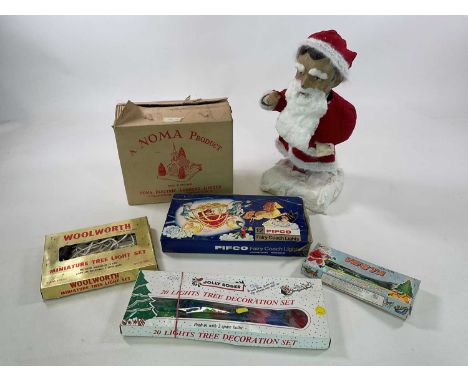 Vintage Christmas items comprising a papier mache Father Christmas, a musical church and four sets of lights. Pifco fairy coa