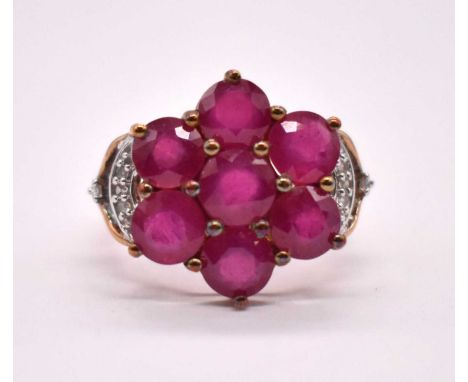 A 9ct yellow gold simulated ruby dress ring with large floral setting, size N 1/2, approx. 3.6g.