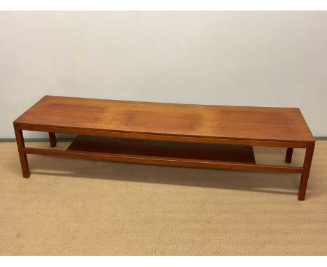 A mid 20th century teak coffee table with magazine shelf, height 38cm, width 168cm, depth 46cm.