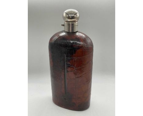 JAMES CLARK &amp; JOHN SEWELL; a massive Edwardian crocodile skin hallmarked silver mounted flask, the hinged cover set with 