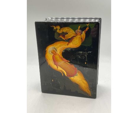 PEGOCKUHO; a Russian lacquered rectangular trinket box inscribed to inside of lid, raised on four squat bun feet, width 18cm.