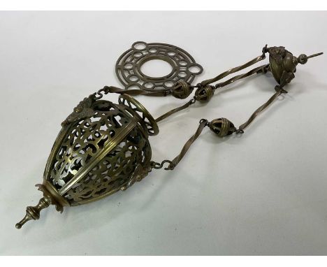 A brass pendant light with pierced sections supported by three brass twist supports, height approx 80cm.
