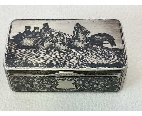 A Russian silver niello snuff box of rounded rectangular form, the hinged lid decorated with a troika and with scroll decorat