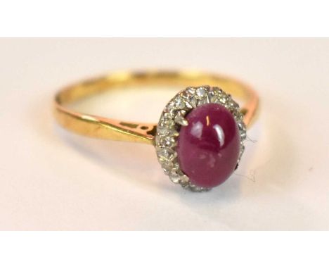 An 18ct yellow gold platinum tipped star ruby and diamond chip ring, size M 1/2, approx. 2.7g. 