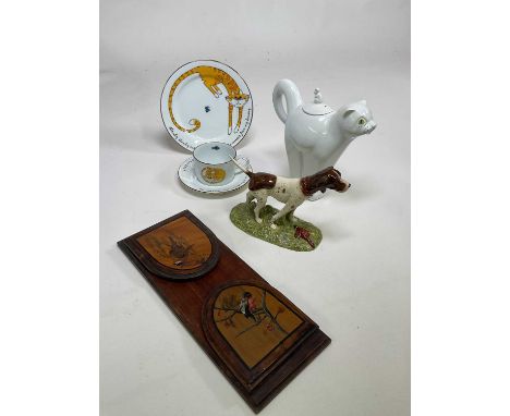 A collection of ceramics comprising a Carltonware cat teapot, Royal Doulton dog, Karen Weston trio decorated with a cat, and 