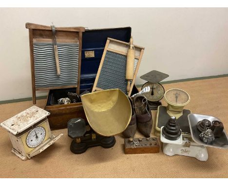 A quantity of metalware and kitchenalia, including kitchen scales, bathroom scales, washboards and other items in a tin trunk