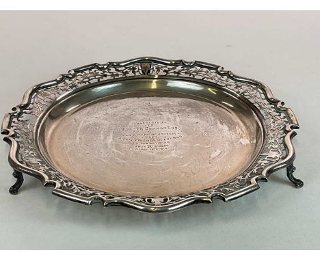 An Edwardian hallmarked silver circular tray with pierced border, inscribed 'Presented to Walter Common Esq as a mark of este