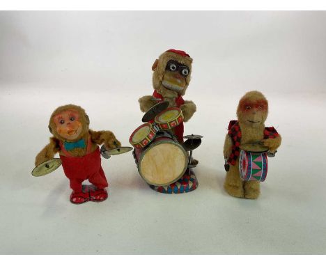 A mid century Japanese drumming monkey, battery operated, height 24cm, with two smaller mechanical monkeys playing a drum and