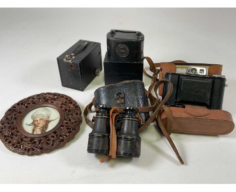 A cased Agfa camera, a pair of field glasses, a box camera, money box and a carved Chinese circular frame (5).