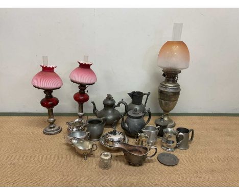 A quantity of plated ware, a silver topped dressing table pot, pewter and three oil lamps with glass shades.Condition Report: