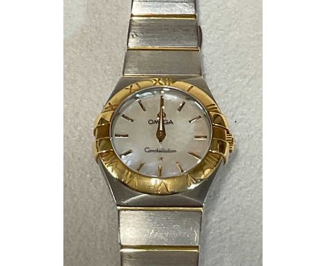 OMEGA; a lady's two tone Constellation wristwatch with mother of pearl dial and baton hour markers, with pouch, inner and out