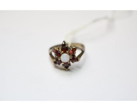 Yellow metal Opal and Garnet set ring Size N. 3.5g total weight 