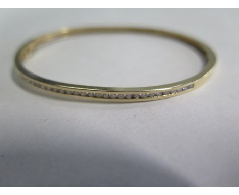 A 14ct diamond set bangle, approx 7.5 gs  ,5cm x 6.5cm - minor usage marks, overall good condition 