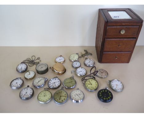 Twenty assorted pocket watches and a pocket barometer, all for spares or repair, in a small three drawer cabinet 