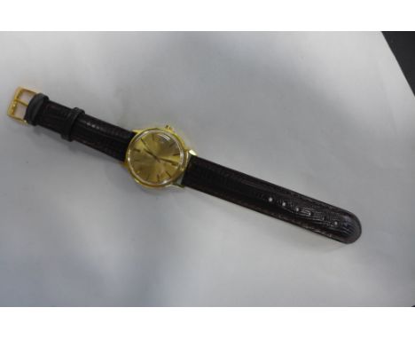 A gents gold plated Omega automatic Geneve wristwatch with date aperture an leather strap - 36mm wide including button, hands