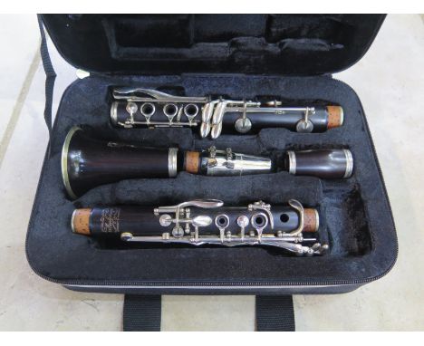 A Boosey and Hawkes, Marlborough, rosewood five piece clarinet, with fitted case, a Konig and Meyer clarinet stand and three 