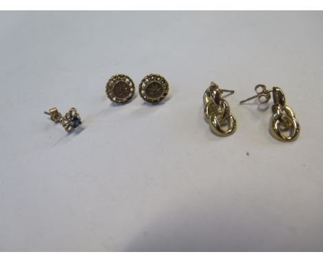 A pair of 9ct gold and diamond earrings, 9mm diameter, and single blue sapphire stud earring with yellow metal mount and a 9c