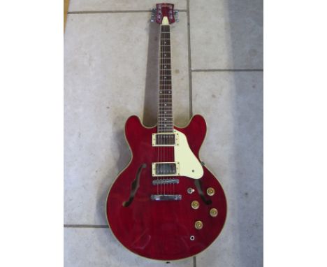 A Tanglewood Memphis semi-electric guitar with two humbucker pick ups, locking tuners, cherry red gloss finish with cream bin