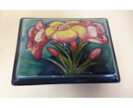 A Moorcroft trinket box - 12cm wide, flowers on blue background - in good condition, some crazing 