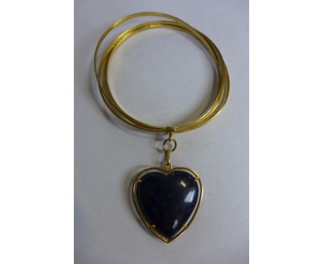 An 18ct yellow gold bangle with a lapis lazuli heart pendant, 7.5cm diameter, pendant 3.5cm x 3.5cm, total weight approx 44.8