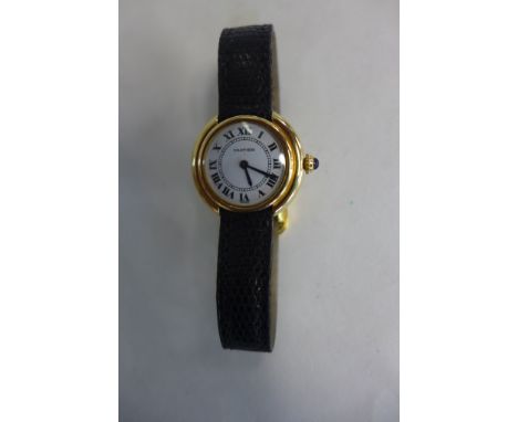 An 18ct yellow gold Cartier Vendome ladies manual wind wristwatch 27mm wide, including button with leather strap and plated b