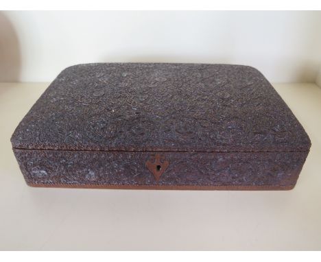 An Eastern style carved hardwood trinket box, covered with ornate floral designs, monogram CMEB - approx 28cm wide, 17.5cm de