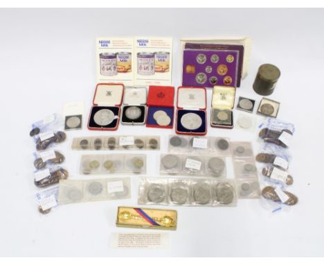 A vintage cash tin containing pre decimal coins, commemorative coins, a Victorian silver crown 1899 and two small replica Ano