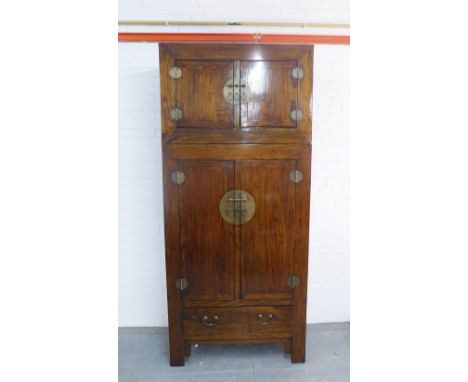 Chinese&nbsp;hardwood wardrobe cabinet, with stylised brass handles and hinges, comprising two parts, the base with two cupbo