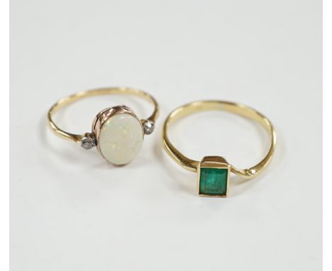 An 18ct &amp; plat, white opal and two stone diamond set ring, size O and an 18k and single stone emerald ring, gross weight 