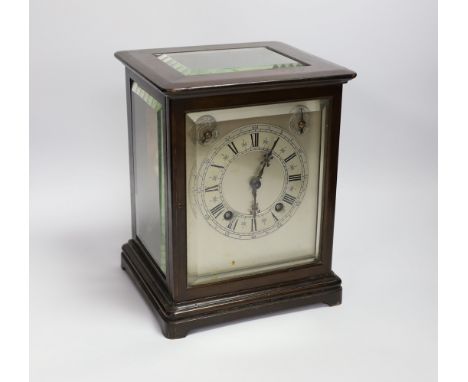 A mahogany striking mantel clock with silvered dial and German movement, 26cm high