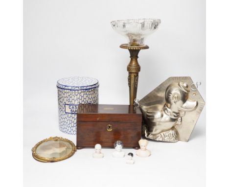 A novelty duck jelly mould, a pottery canister, a tea caddy, miniature dolls heads and a table lamp base, largest 34cm high