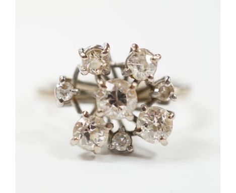 A modern 18ct white gold and graduated eight stone diamond cluster set dress ring, size S, gross weight 7 grams.