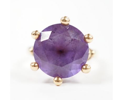 A yellow metal and single stone synthetic colour change corundum set ring, size P/Q, gross weight 6.6 grams.
