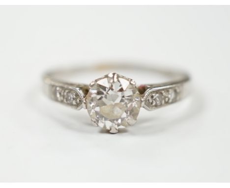 A white metal (stamped plat) and single stone diamond ring with diamond set shoulders, size M/N, gross weight 2.6 grams.