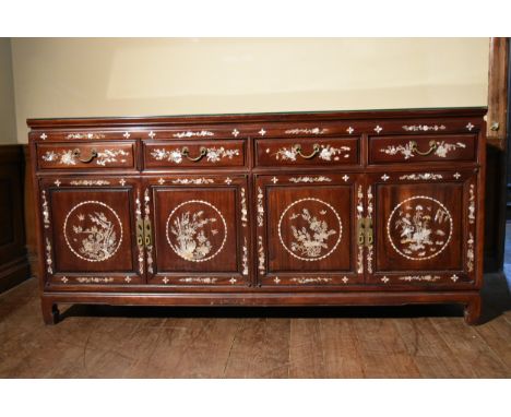 A Chinese hardwood sideboard with profuse all over mother of pearl inlay. H.88 W.184 D.57cm 
