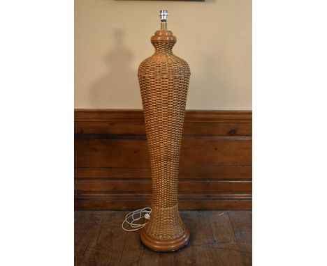 A vintage wicker standard lamp of shaped bulbous form. H.138cm 