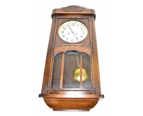 An early 20th century oak wall clock, the circular dial set with Arabic numerals, length 78cm.