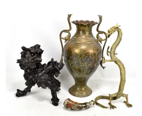 An Eastern brass twin handled vase with cobra handles, a brass dragon, a rootwood carving of a chi chi and a small powder fla