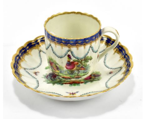 WORCESTER; an 18th century first period coffee cup and saucer decorated with exotic birds within landscapes beneath swags and