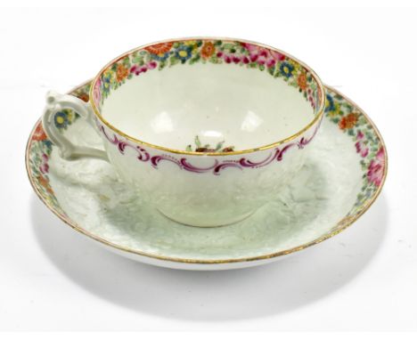 WORCESTER; an 18th century first period cup and saucer decorated in the 'Packling Parrot' pattern, with moulded panel of flor